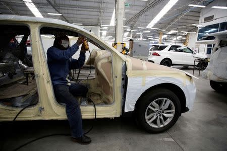 An employee works on an armored vehicle at the garage of Blindajes EPEL company in Mexico City, Mexico April 9, 2018. Picture taken April 9, 2018. REUTERS/Gustavo Graf