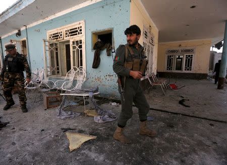 Afghan security forces inspect the site of a suicide attack in Jalalabad, Afghanistan January 17, 2016. REUTERS/ Parwiz