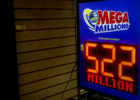 A sign displays that the Mega Millions Lottery prize is estimated $522 million, before the drawing, at a newsstand in the Brooklyn borough of New York City, U.S., July 24, 2018. REUTERS/Brendan McDermid