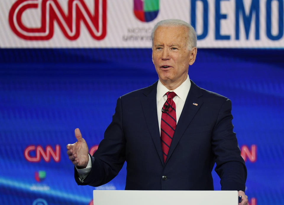In this Sunday, March 15, 2020, photo, former Vice President Joe Biden, with Sen. Bernie Sanders, I-Vt., speaks during a Democratic presidential primary debate at CNN Studios in Washington. What might be the final showdown between the two very different Democratic candidates takes place Tuesday, March 17, 2020, during Florida's presidential primary. (AP Photo/Evan Vucci)