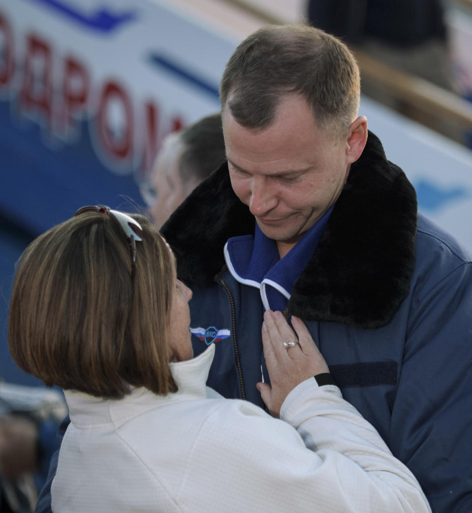 Expedition 57 Flight Engineer Nick Hague of NASA embraces his wife Catie after landing at the Krayniy Airport with Expedition 57 Flight Engineer Alexey Ovchinin of Roscosmos, Thursday, Oct. 11, 2018, in Baikonur, Kazakhstan, after an emergency landing following the failure of a Russian booster rocket carrying them to the International Space Station. (Bill Ingalls/NASA via AP)