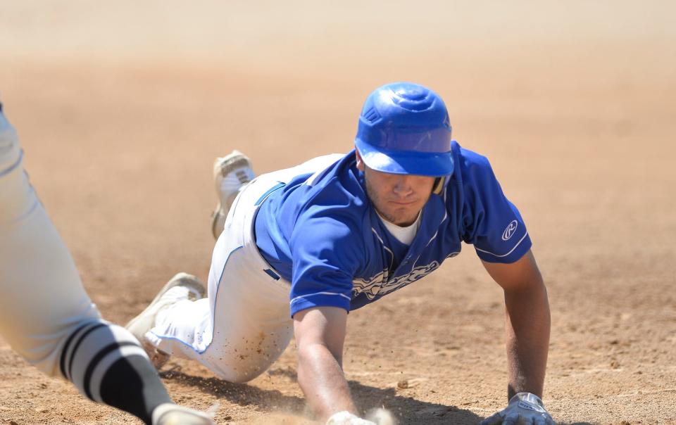 St. Martin's Brady Goebel dives into first on a pick off attempt as St. Martin defeated Cold Spring 9-1 at Cold Spring Baseball Park on Saturday, Aug. 14, 2021. 