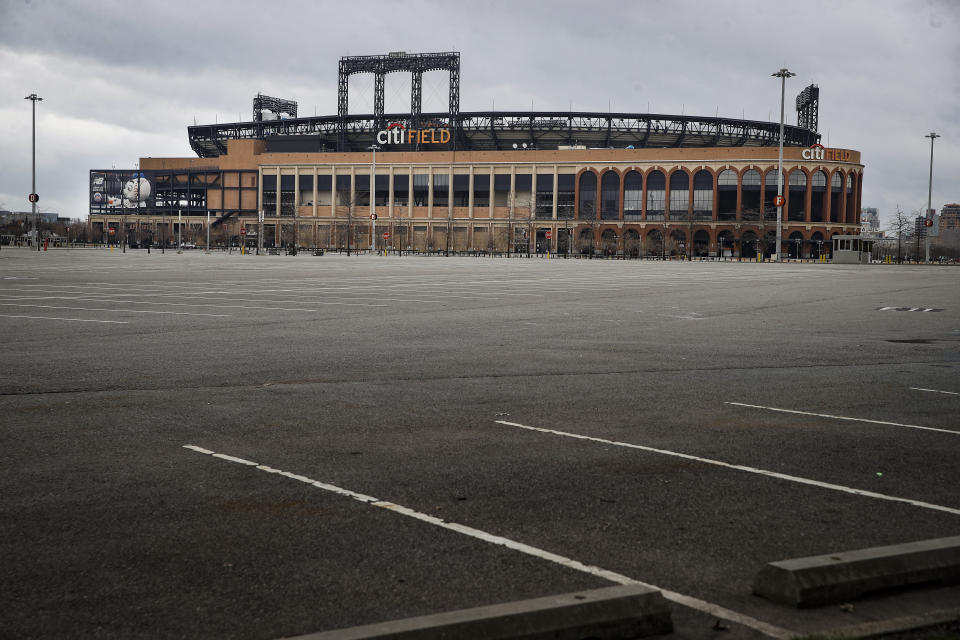 FILE - This March 25, 2020 file photo shows the empty parking lot surrounding Citifield, the home of the New York Mets, in the Queens borough of New York. The Yankees and Mets would train in New York if Major League Baseball and its players try to start the coronavirus-delayed season. New York Gov. Andrew Cuomo made the announcement Saturday, June 20, 2020, and the teams confirmed the decisions. (AP Photo/John Minchillo)