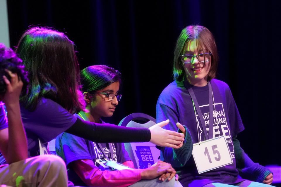 Isabelle Garcia (15) high-fives Aliyah Alpert after successfully spelling her word during the Arizona Spelling Bee at the Madison Center for the Arts in Phoenix on March 16, 2024.
