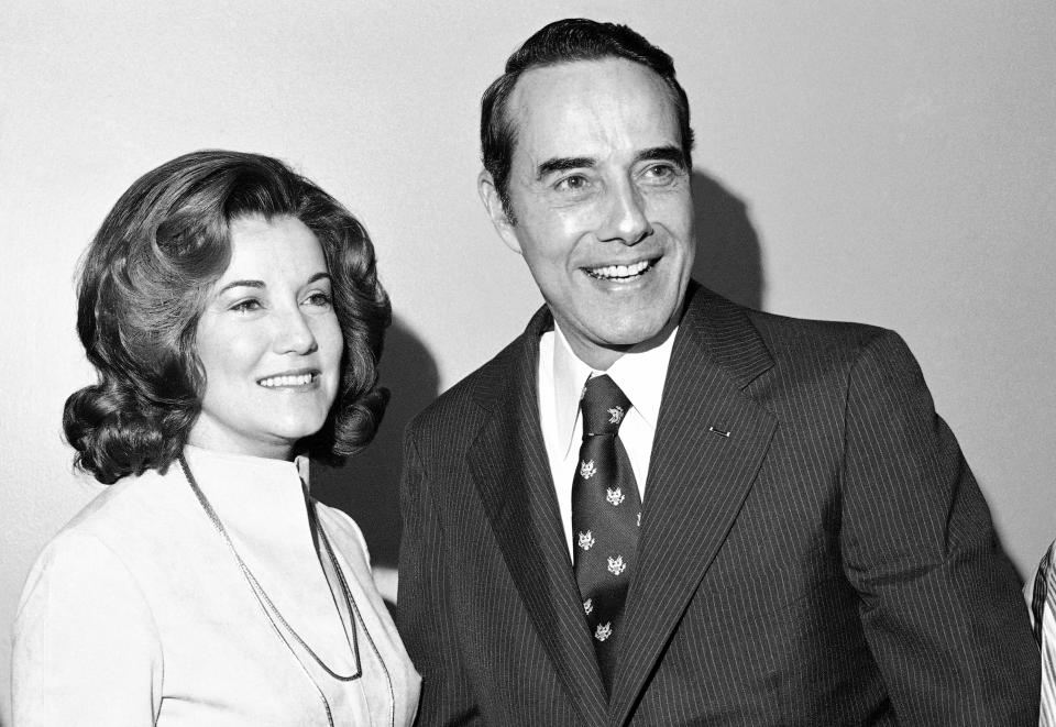 FILE - Sen. Robert Dole, R-Kan., poses with his bride-to-be Elizabeth Hanford of Salisbury, N.C., on Saturday, Dec. 6, 1975, at a wedding breakfast in Washington. Bob Dole, who overcame disabling war wounds to become a sharp-tongued Senate leader from Kansas, a Republican presidential candidate and then a symbol and celebrant of his dwindling generation of World War II veterans, has died. He was 98. His wife, Elizabeth Dole, posted the announcement Sunday, Dec. 5, 2021, on Twitter. (AP Photo/Harvey Georges, File)