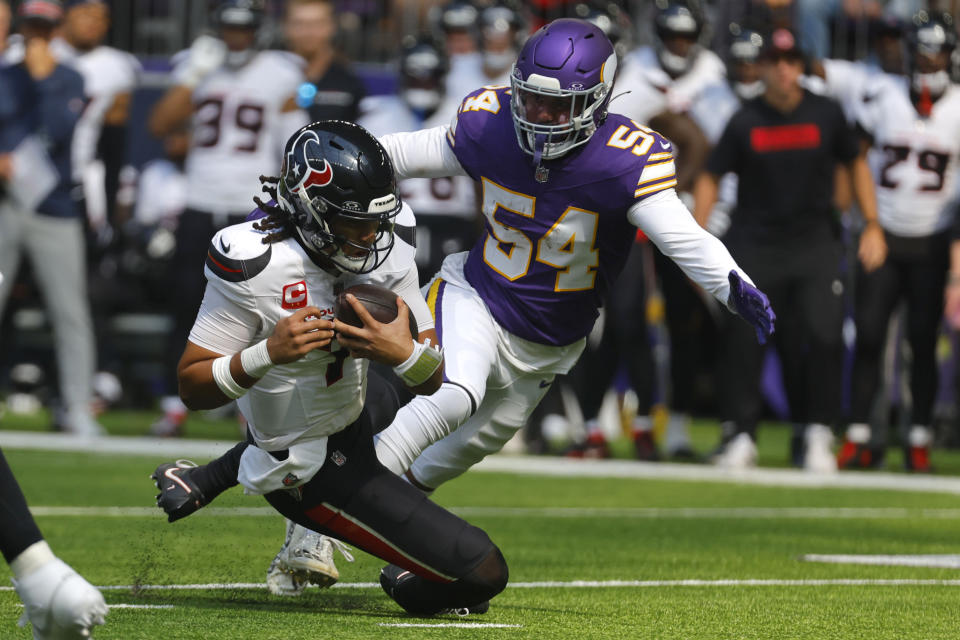 Houston Texans quarterback C.J. Stroud (7) slides to the turf in front of Minnesota Vikings linebacker Kamu Grugier-Hill (54) during the first half of an NFL football game, Sunday, Sept. 22, 2024, in Minneapolis. (AP Photo/Bruce Kluckhohn)