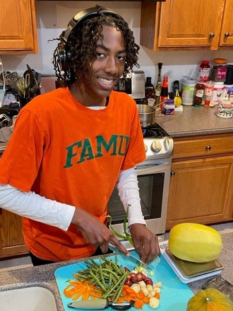 FAMU student Corey Lawrence prepares a vegan dinner of spaghetti squash with sautéed mixed veggies.