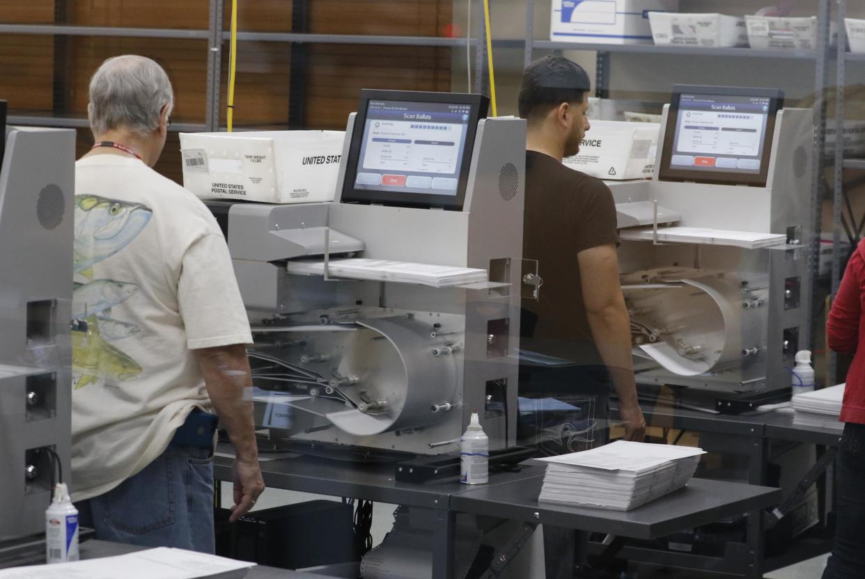 Florida elections staff load ballots into machines as the statewide vote recount is being conducted to determine the races for governor, Senate, and agriculture commissioner: Joe Skipper/Getty Images