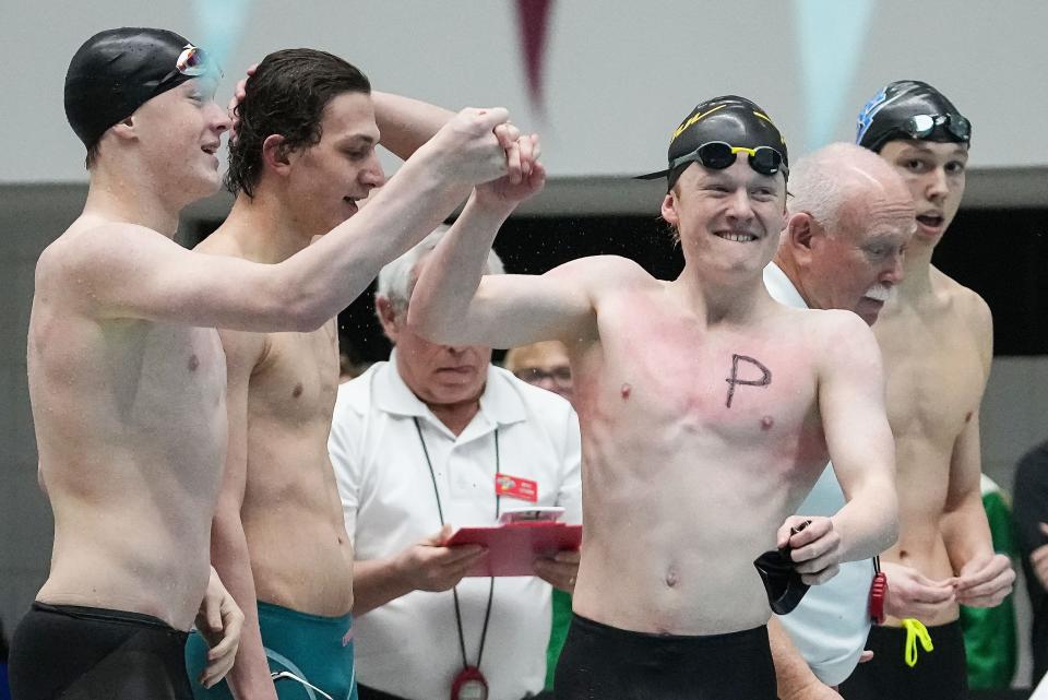 Penn swimmers celebrating placing third in the 200 yard medley relay during the IHSAA swimming and diving state finals on Saturday, Feb. 25, 2023 at IIUPUI Natatorium in Indianapolis. 