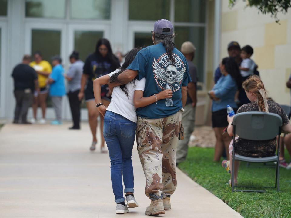 Families gather and hug outside the Willie de Leon Civic Center where grief counseling will be offered in Uvalde, Texas, on May 24, 2022. - A teenage gunman killed 18 young children in a shooting at an elementary school in Texas on Tuesday, in the deadliest US school shooting in years. The attack in Uvalde, Texas -- a small community about an hour from the Mexican border -- is the latest in a spree of deadly shootings in America, where horror at the cycle of gun violence has failed to spur action to end it.