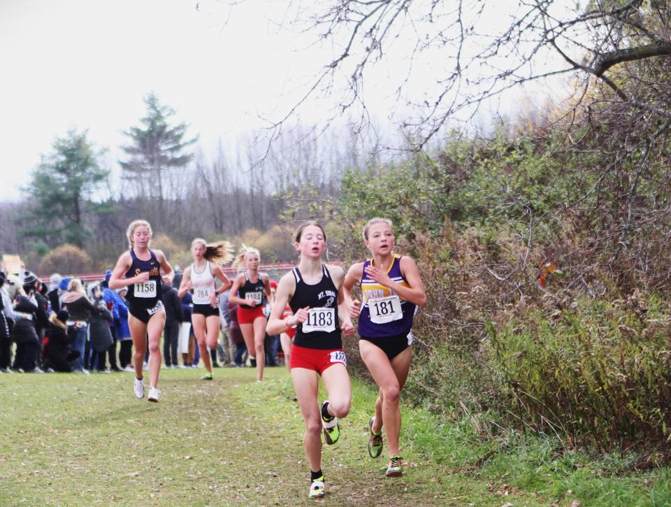 John Jay-Cross River's Sloan Wasserman (r) and Sinai's Cali Gabrielson (l) run side-by-side during the girls Class B state cross-country championship Nov. 11, 2023 in Vernona, New York. Gabrielson was second and Wasserman third in the 115-finisher race.