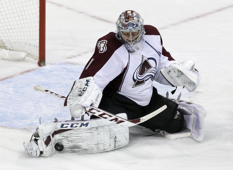 Colorado Avalanche goalie Semyon Varlamov (1), of Russia, stops a shot from the Dallas Stars in the third period of an NHL hockey game, Monday, Jan. 27, 2014, in Dallas. Varlamov made 41 saves in the 4-3 Avalanche win. (AP Photo/Tony Gutierrez)