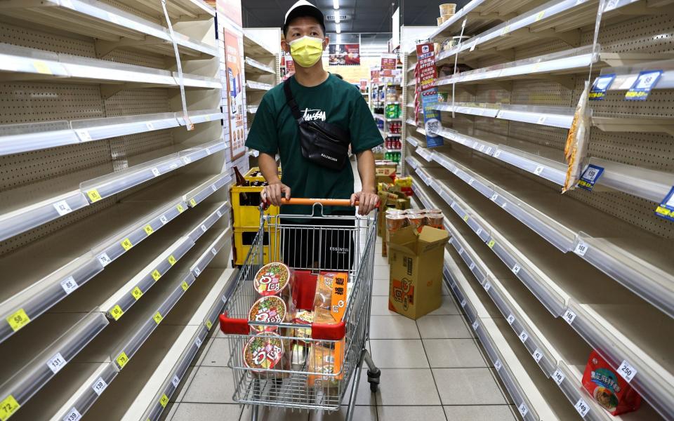 A customer attempts to grocery shop in Taipei - REUTERS/Ann Wang