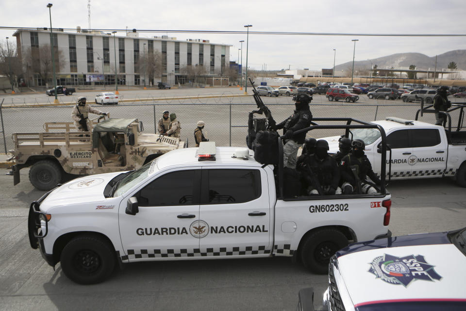 Mexican National Guard stand guard outside a state prison in Ciudad Juarez, Mexico, Sunday Jan 1, 2023. Mexican soldiers and state police regained control of a state prison in Ciudad Juarez across the border from El Paso, Texas after violence broke out early Sunday, according to state officials. (AP Photo/Christian Chavez)