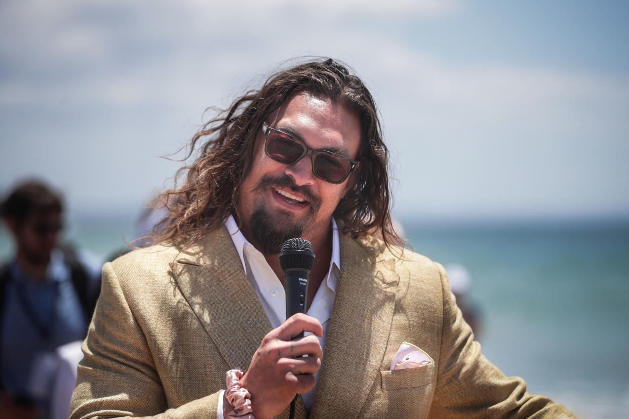 US actor Jason Momoa delivers a speech during the Youth and Innovation Forum at Carcavelos beach in Oeiras, outskirts of Lisbon on June 26, 2022. (Photo by CARLOS COSTA / AFP) (Photo by CARLOS COSTA/AFP via Getty Images)