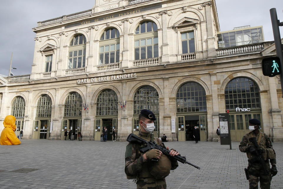 French soldiers patrol next to the station in Lille northern France, Friday, Oct. 30, 2020. France re-imposed a monthlong nationwide lockdown Friday aimed at slowing the spread of coronavirus, closing all non-essential business and forbidding people from going beyond one kilometer from their homes except to go to school or a few other essential reasons. (AP Photo/Michel Spingler)