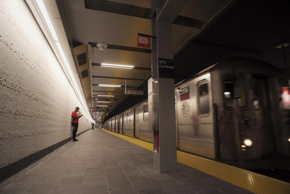 A downtown 1 train pulls into the newly-opened WTC Cortlandt subway station in New York on Saturday evening, Sept. 8, 2018. The old Cortlandt Street station on the subway system's No. 1 line was buried under the rubble of the World Trade Center's twin towers on Sept. 11, 2001. Construction of the new station was delayed until the rebuilding of the surrounding towers was well under way. (AP Photo/Patrick Sison)