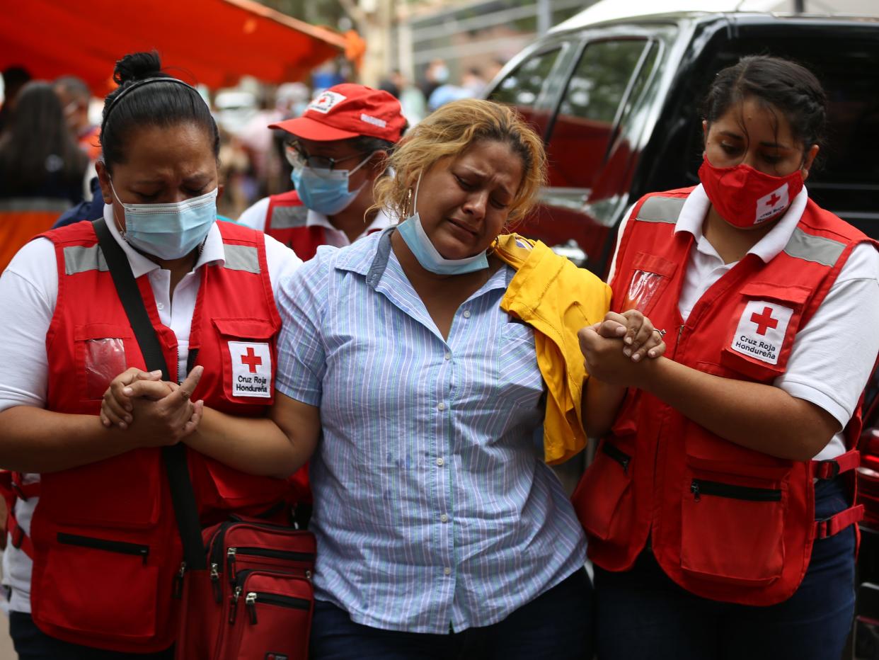 A relative cries after she receives the body of loved one who was killed in a riot at women's prison.