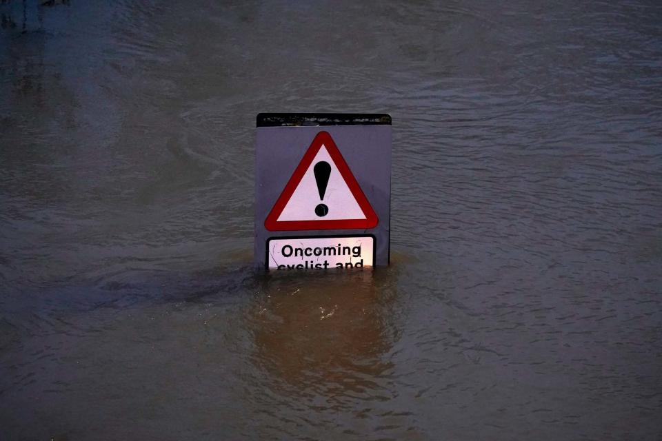 A street sign is part submerged by floodwater after the River Severn burst its banks (Getty Images)