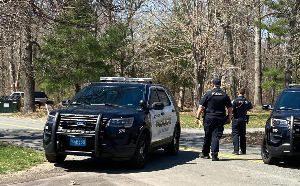 Police block a road in North Dighton, Mass., Thursday, April 13, 2023. The FBI wants to question a 21-year-old member of the Massachusetts Air National Guard in connection with the disclosure of highly classified military documents on the Ukraine war, two people familiar with the investigation said. (AP Photo/Michelle R. Smith)