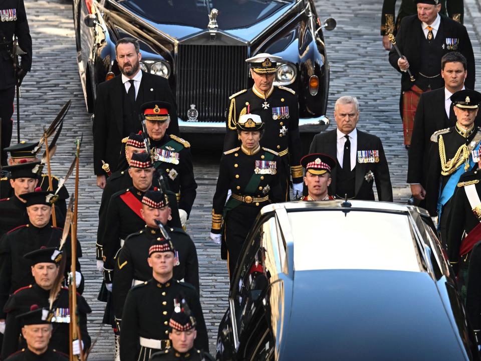King Charles III and his siblings walk together behind a car carrying their mother's coffin in Edinburgh.