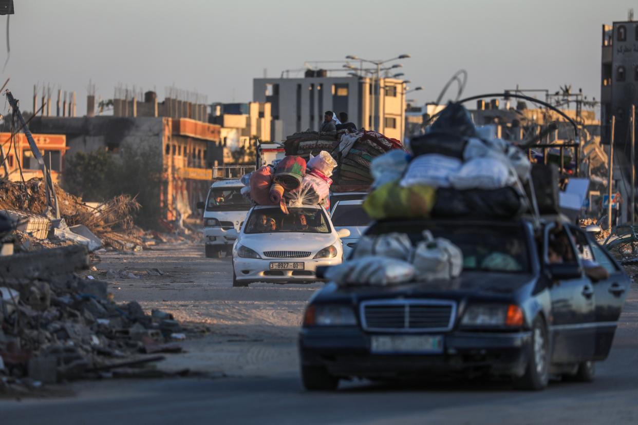 Dozens of cars leave the southern Gaza city of Rafah as Israel begins its offensive in the area (EPA)