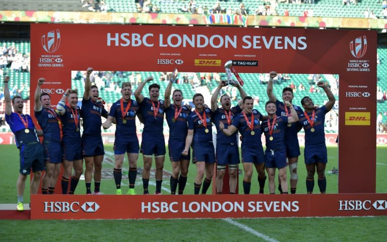 The Scotland team celebrates with the trophy after their victory at Twickenham in south west London on May 21, 2017