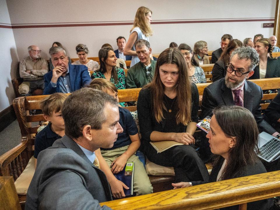 Young plaintiffs in a Montana courtroom confer with their lawyers