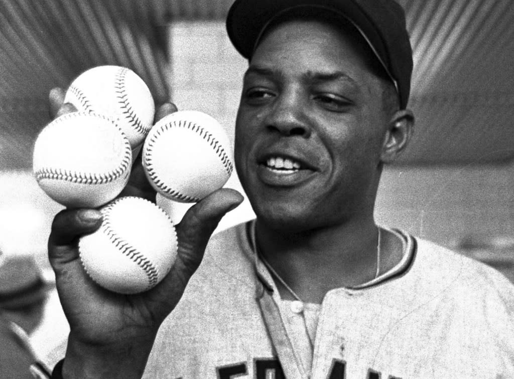 San Francisco Giants outfielder Willie Mays displays the four baseballs in the clubhouse representing the four homers which he hit against the Milwaukee Braves, April 30, 1961, in Milwaukee. (AP Photo, File)