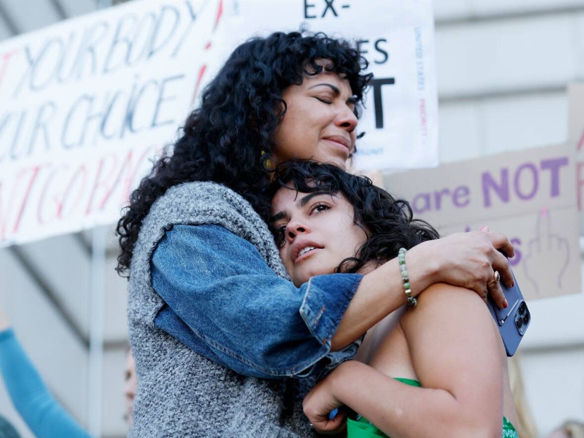 Mitzi Rivas hugs daughter Maya Iribarren as abortion-rights protesters gather following the U.S. Supreme Court's decision to overturn Roe v. Wade in San Francisco, Friday. (Josie Lepe/The Associated Press - image credit)