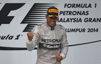 Lewis Hamilton celebrates on the podium after winning the Malaysian Grand Prix in Sepang on March 30, 2014