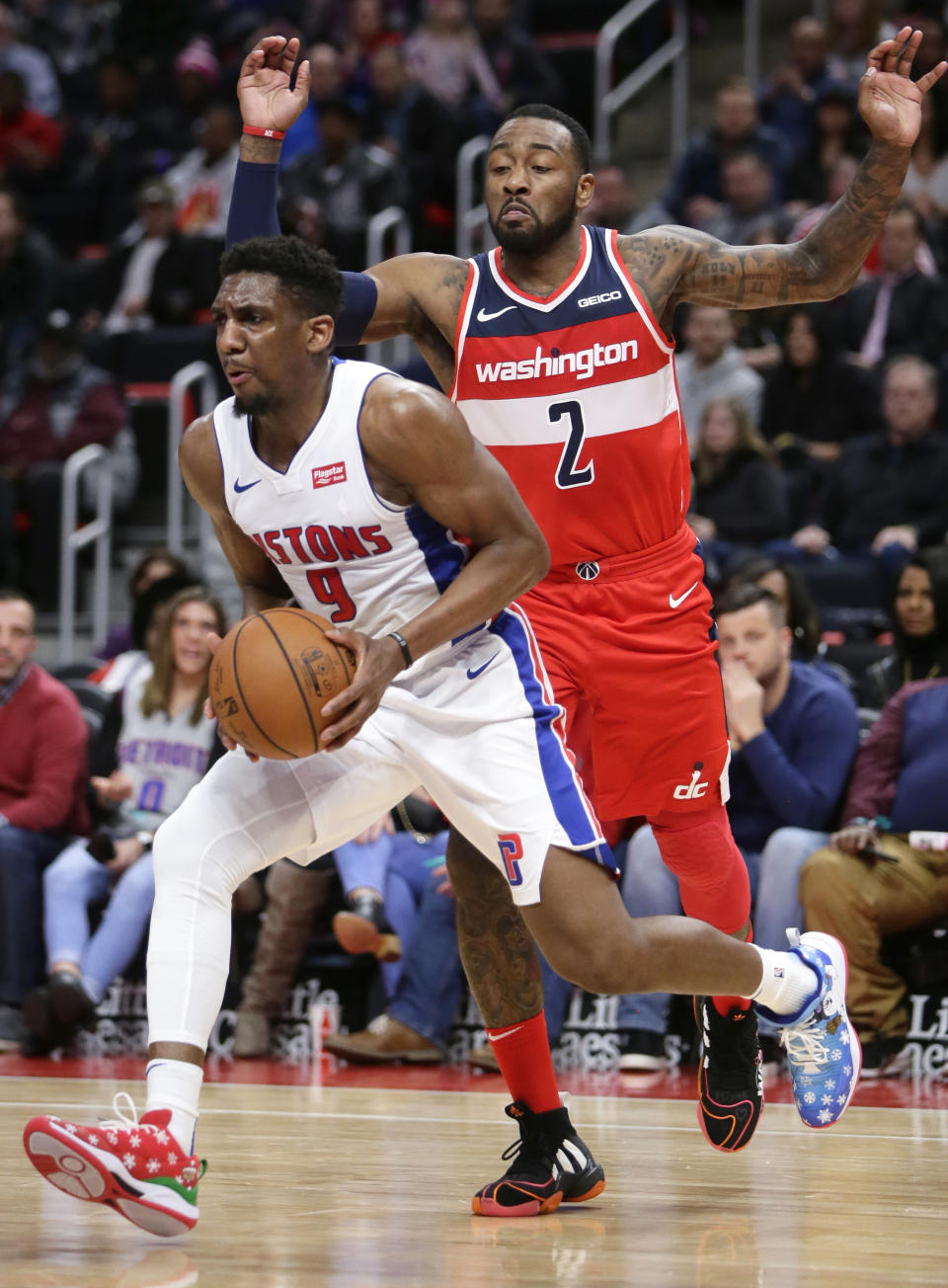 Detroit Pistons guard Langston Galloway (9) drives to the basket past Washington Wizards guard John Wall (2) during the first half of an NBA basketball game Wednesday, Dec. 26, 2018, in Detroit. (AP Photo/Duane Burleson)