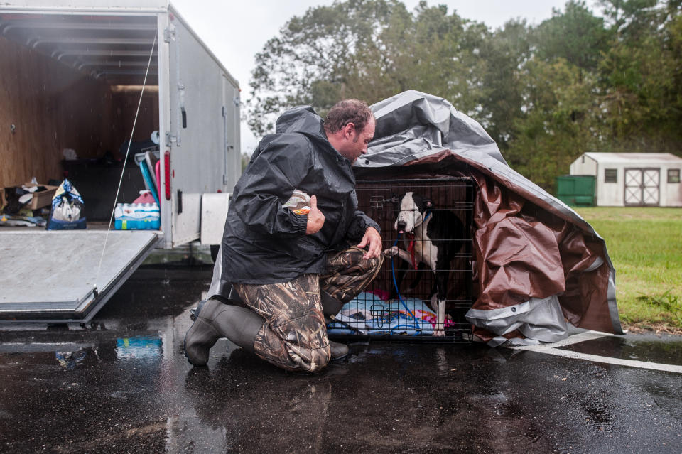 Scott brings food to a dog he rescued from the flooded streets of Lumberton on Sunday.