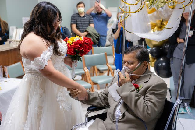 <p>David Patton</p> Michelle Avila holds her father Jose Antonio Avila's hand