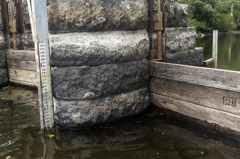 A measuring stick at the Nemasket River gates show historically low water levels at about 6 inches, nearing the record low seen in 2016.