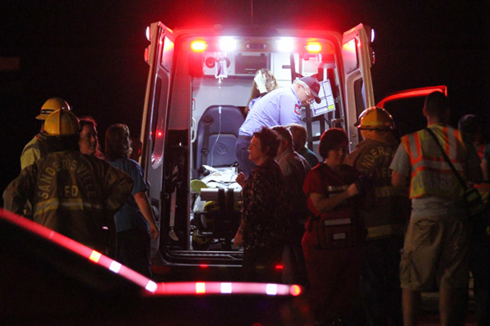 Emergency responders, members of Freedom Baptist Church, and Myrick community members in rural Jones County, Miss. gather near an ambulance outside the Freedom Baptist Church Wednesday night after a second floor youth room collapsed onto a first floor kitchen. Up to 35 youth ages from seventh grade to 12th grade were injured. A 16-year-old girl who suffered a head injury was airlifted to Forrest General Hospital in Hattiesburg. (AP Photo/The Chronicle, James Pugh)