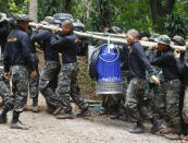 <p>Soldiers carry a pump to help drain the rising floodwater in a cave where 12 boys and their soccer coach had been trapped since June 23, in Mae Sai, Chiang Rai Province, in northern Thailand, Friday, July 6, 2018. (Photo: Sakchai Lalit/AP) </p>