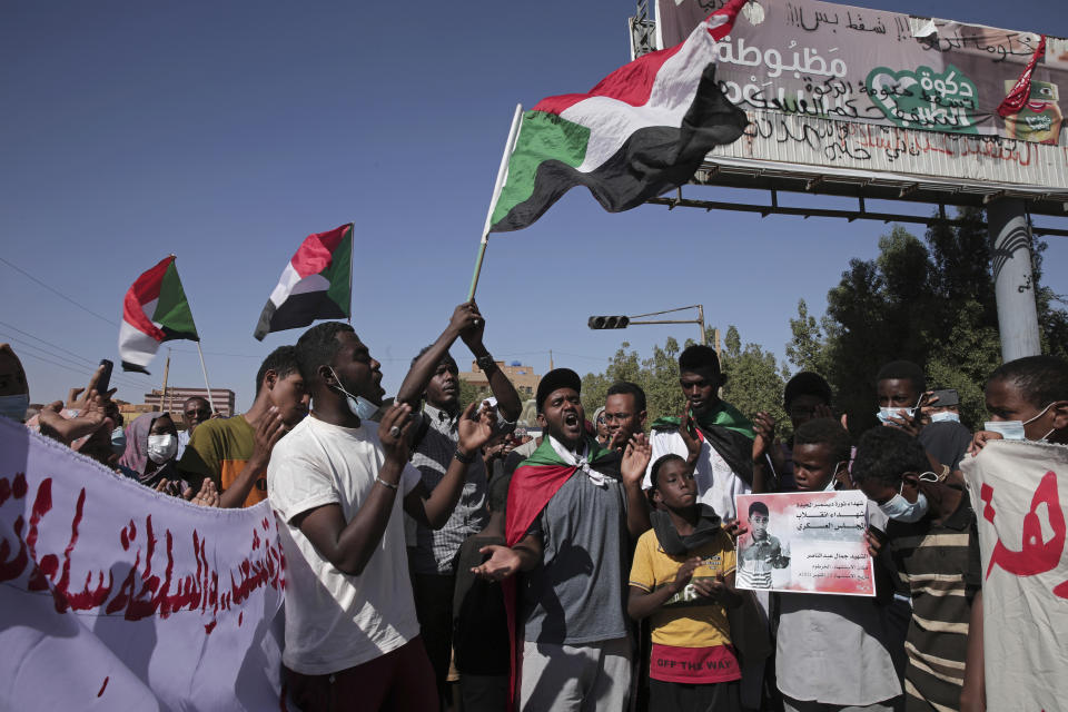 Thousands of protesters take to the streets to renew their demand for a civilian government in the Sudanese capital Khartoum, Thursday, Nov. 25, 2021. The rallies came just days after the military signed a power-sharing deal with the prime minister, after releasing him from house arrest and reinstating him as head of government. The deal came almost a month after the generals orchestrated a coup. Sudan’s key pro-democracy groups and political parties have dismissed the deal as falling short of their demands for a fully civilian rule. (AP Photo/Marwan Ali)