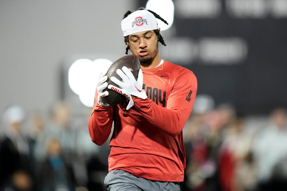 Ohio State Buckeyes wide receiver Jaxon Smith-Njigba  catches a pass from quarterback C.J. Stroud during Ohio State football’s pro day at the Woody Hayes Athletic Center in Columbus on March 22, 2023. 