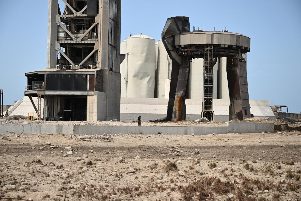 A member of the public walks through a debris field at the launch pad on April 22, 2023, after the SpaceX Starship lifted off on April 20 for a flight test from Starbase in Boca Chica, Texas.