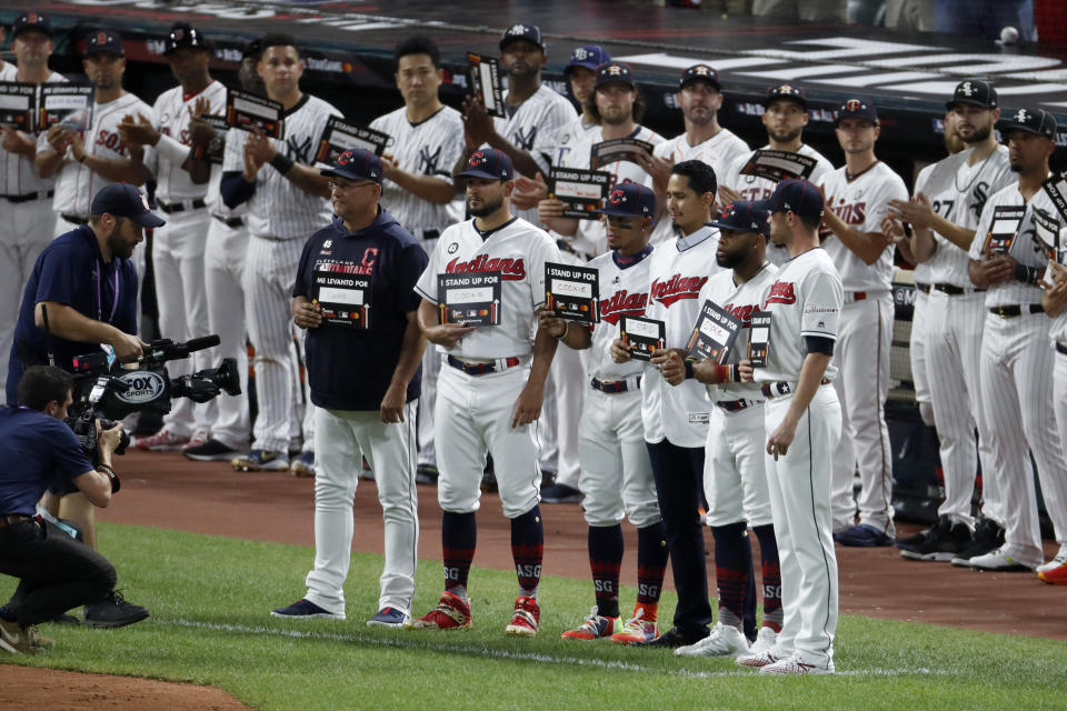 Members of the Cleveland Indians stand with teammate Carlos Carrasco during the "Stand Up To Cancer" ceremony at the 2019 MLB baseball All-Star Game. (AP Photo/Ron Schwane)