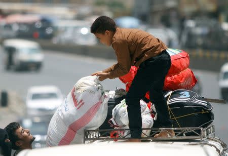 A displaced man from Hodeidah city carries a bag as they reach Sanaa, Yemen June 22, 2018. REUTERS/Mohamed al-Sayaghi