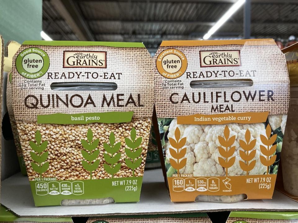 two packages of earthly grains' quinoa and cauliflower meals on shelf at Aldi
