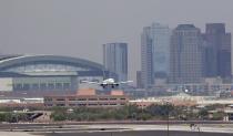 <p>Heat waves ripple across the tarmac at Sky Harbor International Airport as downtown Phoenix stands in the background as an airplane lands, June 20, 2017 in Phoenix. Phoenix hit a high of 118 on Monday with an excessive heat warning in place until Saturday. (Matt York/AP) </p>