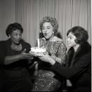 <p>Juliet Prowse and Ella Fitzgerald present their costar, Hermione Gingold, with a birthday cake. The three stars were appearing on <em>The Frank Sinatra Show</em> together. </p>