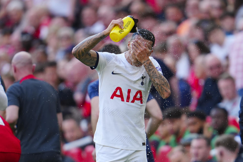 Tottenham's Pedro Porro splashes water on his face during the English Premier League soccer match between Liverpool and Tottenham Hotspur at Anfield Stadium in Liverpool, England, Sunday, May 5, 2024. (AP Photo/Jon Super)