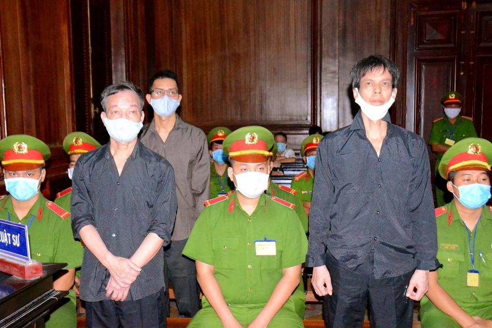 Vietnamese bloggers Pham Chi Dung, right, Nguyen Tuong Thuy and Le Huu Minh Tuan during their trial in Ho Chi Minh city in January. (STR/Vietnam News Agency/AFP via Getty Images)