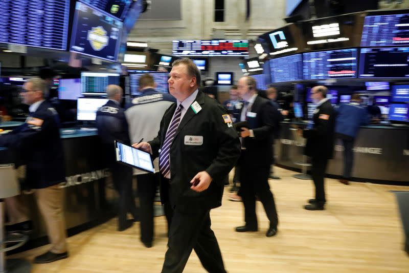 Traders work on the floor at the NYSE in New York