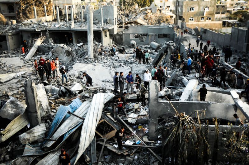 Palestinians search for victims after an Israeli strike on a mosque in Rafah in the southern Gaza Strip on Wednesday. Photo by Ismael Mohamad/UPI