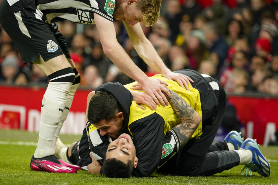 Newcastle's Miguel Almiron celebrates with teammates after scoring his side's opening goal during the EFL Cup fourth round soccer match between Manchester United and Newcastle at Old Trafford stadium in Manchester, England, Wednesday, Nov. 1, 2023. (AP Photo/Dave Thompson)